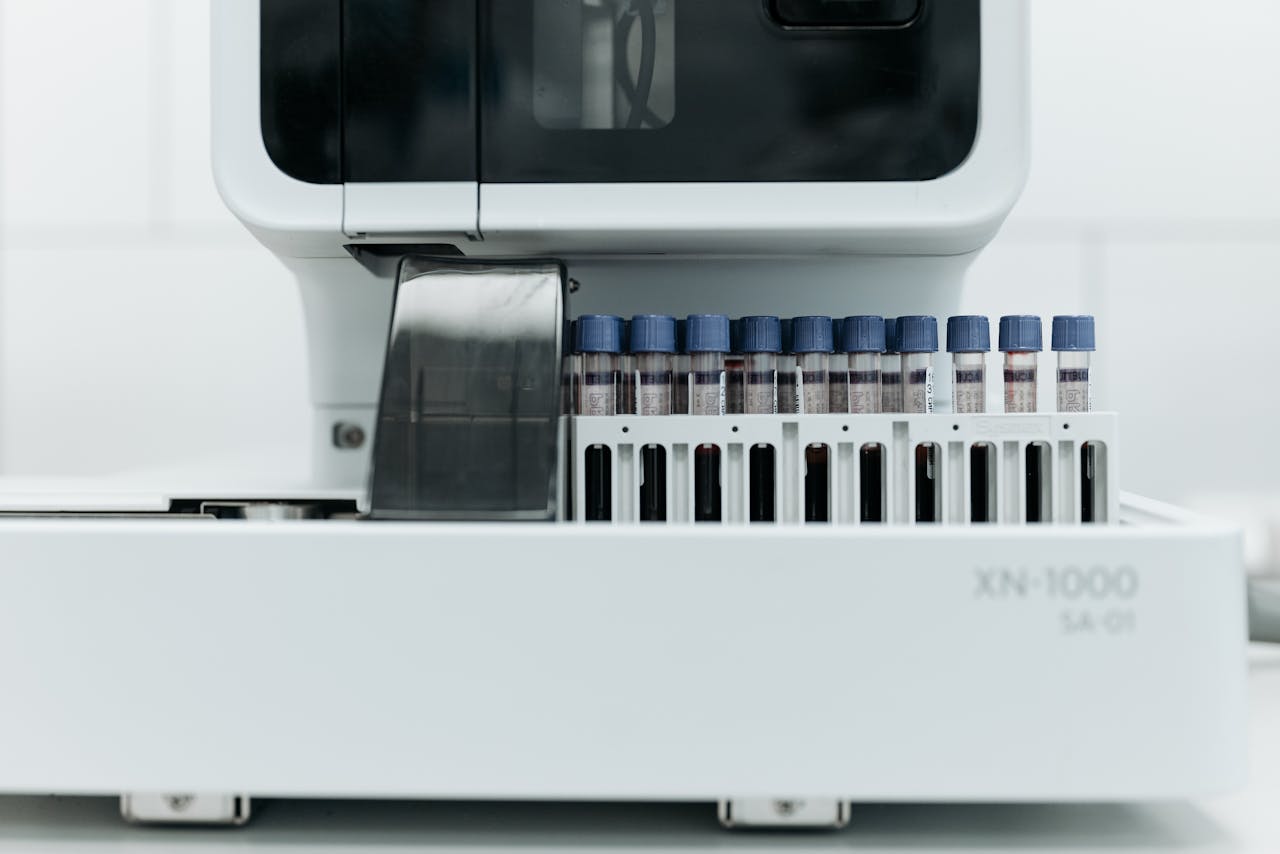 Close-up of laboratory machine holding test tubes for analysis.